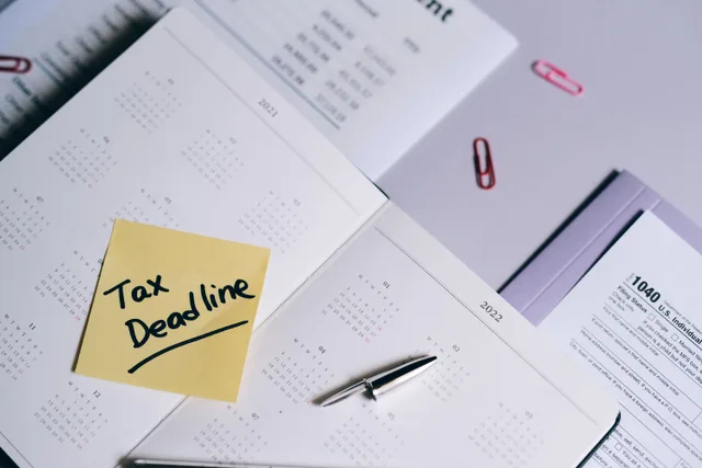 A calendar with a tax deadline note and tax forms, emphasizing organization. Federal business tax rules: the sections behind a return