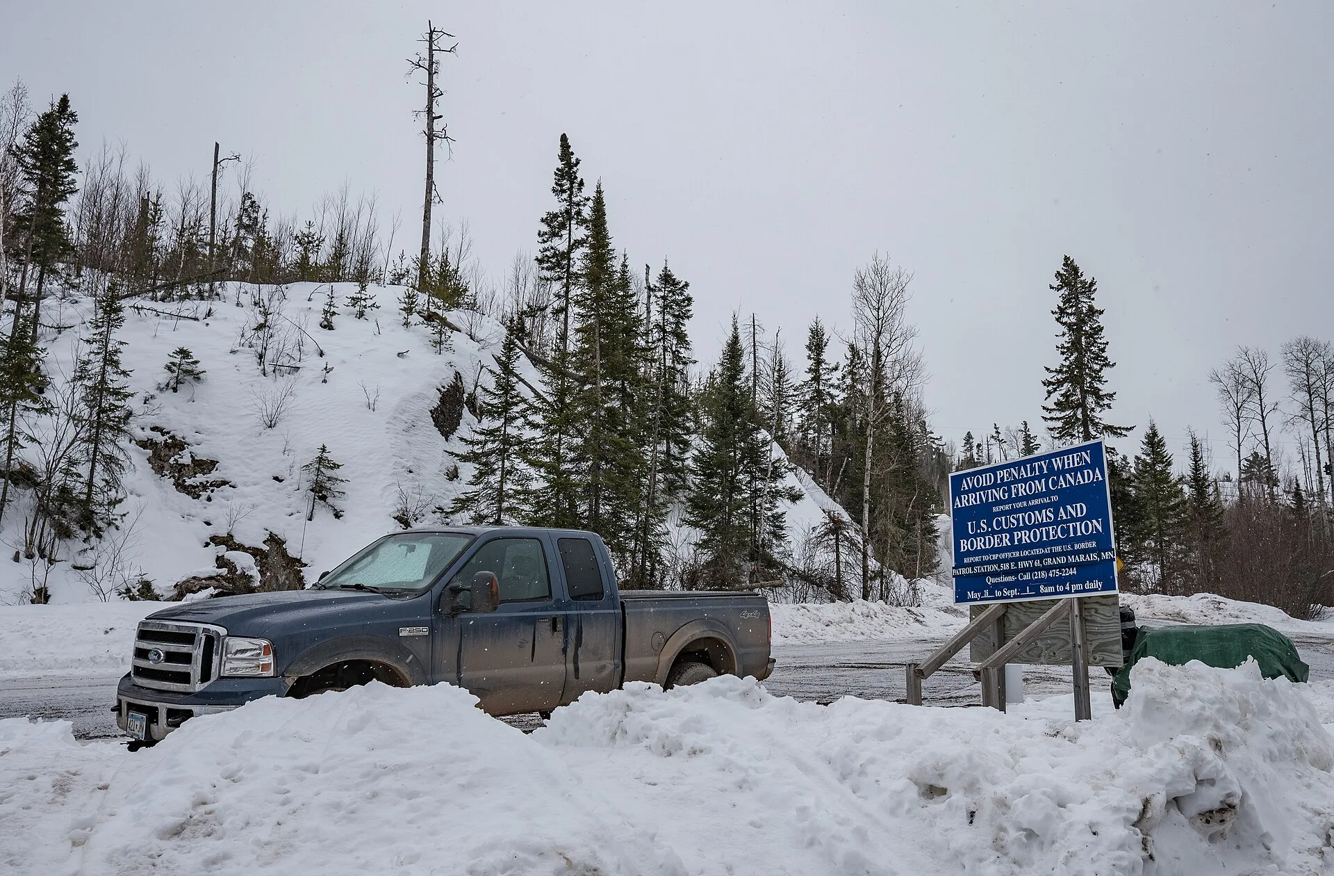 U.S. Customs and Border Protection warning sign on Saganaga Lake on the US-Canada border, Gunflint Trail, Minesota. -- (C) 2018 Tony Webster tony@tonywebster.com +1 202-930-9200. US contractors driving to Canada, a cross-border mileage guide